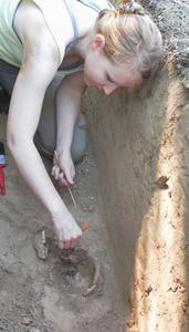 Kathryn Miyar excavating an 18th century historic burial at a French fortification site.